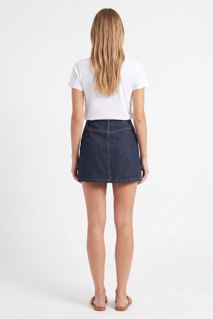 The Cambridge Button-Front Pleated Denim Mini Skirt in Dark Indigo