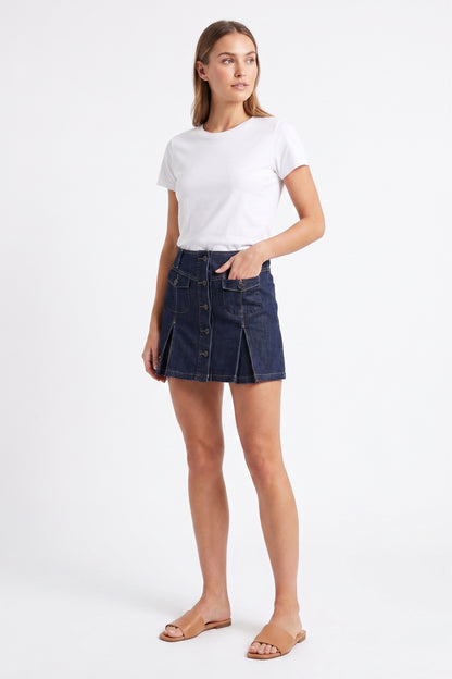The Cambridge Button-Front Pleated Denim Mini Skirt in Dark Indigo